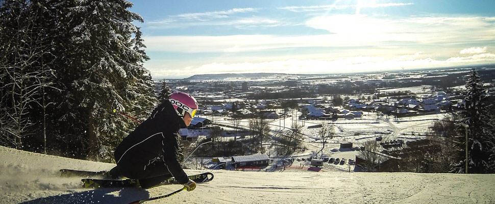 woman skiing downhill. Beautiful view in the background.